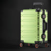 Light green and black rolling aluminum luggage.