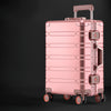 Rose gold rolling aluminum luggage suitcase.