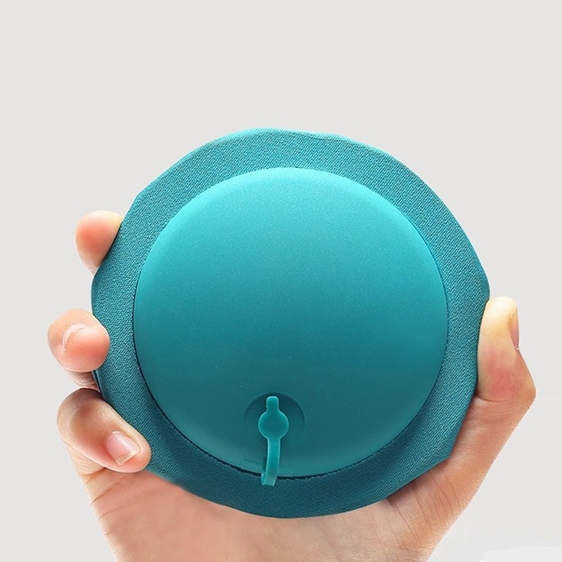 Teal Portable Press Inflatable Neck Pillow is handheld.